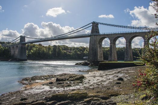 A view of the historic Menai suspension bridge spanning the Menai Straits, Gwynnedd, Wales, UK.