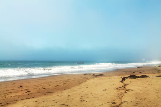 Beach with foggy sky.