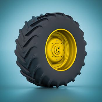 Tractor wheel isolated on blue background