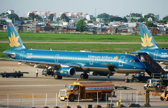 HO CHI MINH CITY, VIET NAM- MAY 6: Airplane at Tan Son Nhat airport to transport, they prepare for new flight, Viet Nam airline is Vietnam nation aeronautic, Vietnam, May 7, 2014