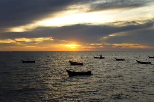Silhouette of boats at sea during sunset