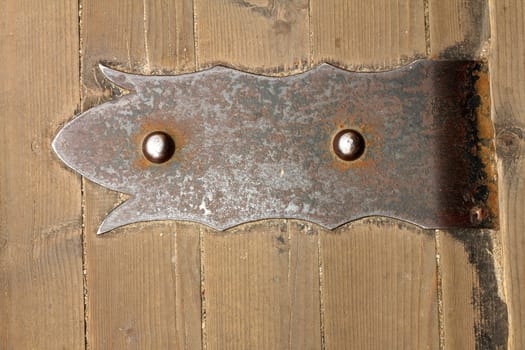 old metallic door hinge, detail taken on old castle