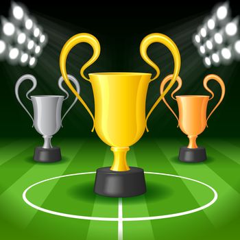 Soccer Background with Bright Spot Lights and Three Award Trophy on Gridiron