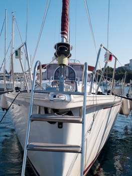 sailboat anchored in port, front view