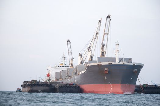 Large cargo ship Boats moored in the sea to make sense compared to the coast.
