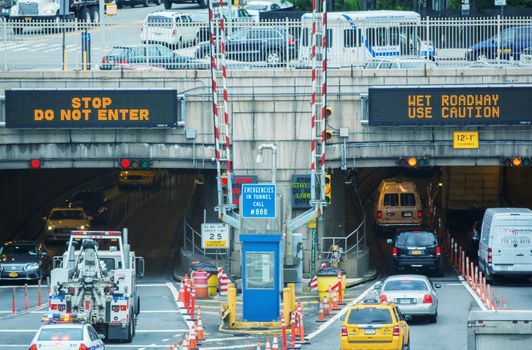NEW YORK CITY - MAY 10, 2014: Entrance of Queens Midtown Tunnel with city traffic. Designed by Ole Singstad, it was opened to traffic on November 15, 1940.