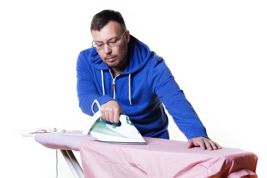 Man doing housework and ironing a shirt