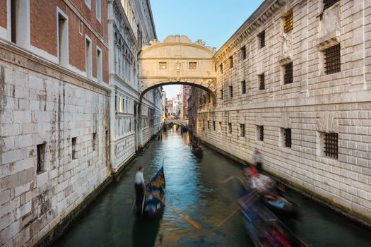 Gondolas passing under Bridge of Sighs, Ponte dei Sospiri. A legend says that lovers will be granted eternal love if they kiss on a gondola at sunset under the Bridge. Venice,Veneto, Italy, Europe. 
