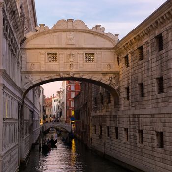 Gondolas passing under Bridge of Sighs, Ponte dei Sospiri. A legend says that lovers will be granted eternal love if they kiss on a gondola at sunset under the Bridge. Venice,Veneto, Italy, Europe. 