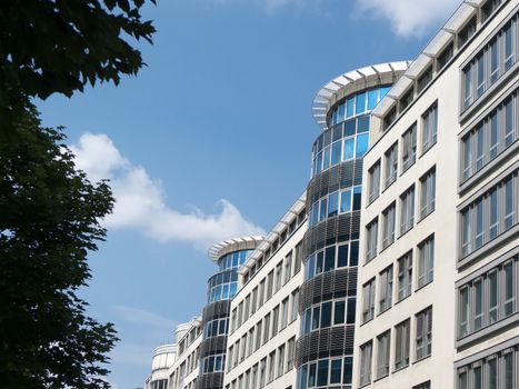 Modern buildings exterior with contemporary architecture design and windows in a beautiful sunny day with blue sky.