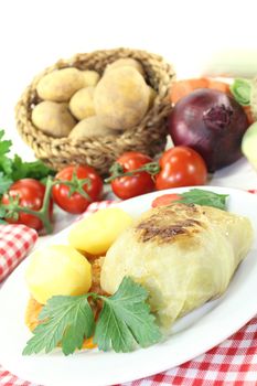 Stuffed cabbage with potatoes and mincemeat on a light background