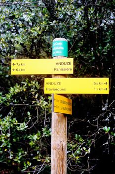 Sign indicating direction with the miles for each entry cities for hikers