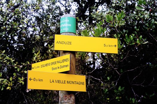 Sign indicating direction with the miles for each entry cities for hikers