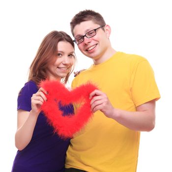 Young cauple in love holding heart and cuddle - studio shoot 