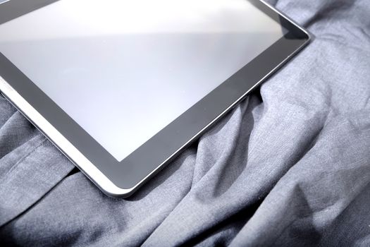 A Tablet PC on some dark cloth.