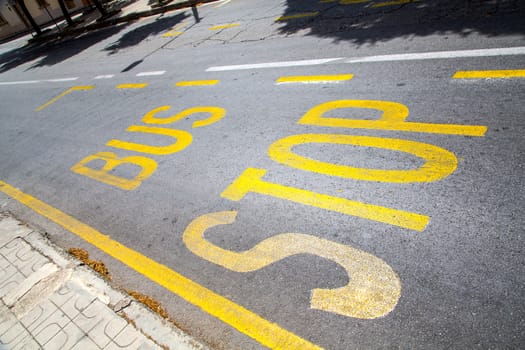 Bus stop written on the street.