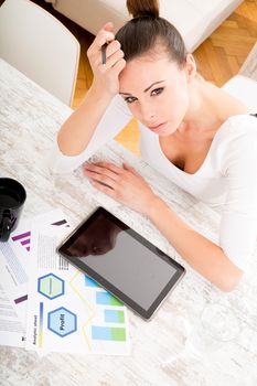 Closeup of a young adult woman with tablet.
