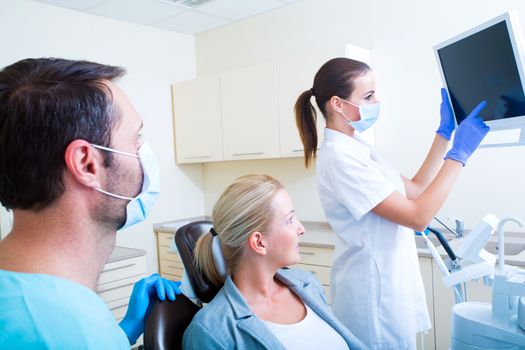 A mature adult woman getting a checkup at the Dentist.
