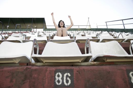 A vintage style cheering girl in a sports stadium.

