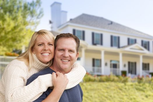 Happy Couple Hugging in Front of Beautiful House.