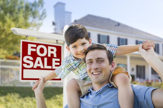 Mixed Race Father and Son Piggyback in Front House and For Sale Real Estate Sign.