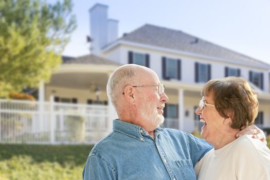 Happy Senior Couple in the Front Yard of Their House.