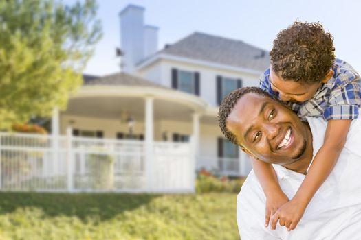 Happy Playful African American Father and Mixed Race Son In Front of House.