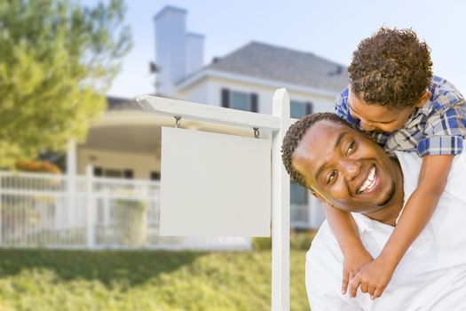 Happy African American Father and Mixed Race Son In Front of Blank Real Estate Sign and New House.