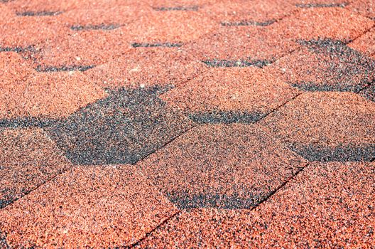 Red asphalt shingle close up view