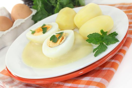 a plate with mustard eggs and potatoes