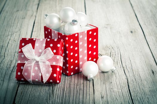 red Christmas gift box, polka dots, on wood background