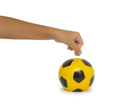 Closeup of woman's hand inserting coin in moneybox