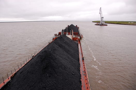 Cargo ship with coal at Kolyma river Russia outback, Yakutia region