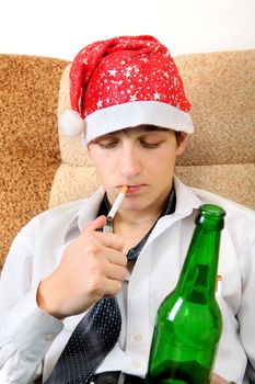 Teenager in Santa Hat with Bottle of the Beer smoking Cigarette