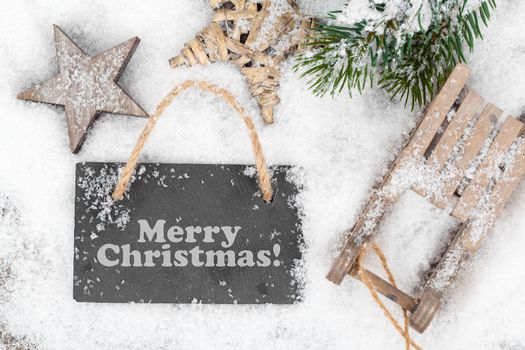 Christmas decoration over snow, wooden background