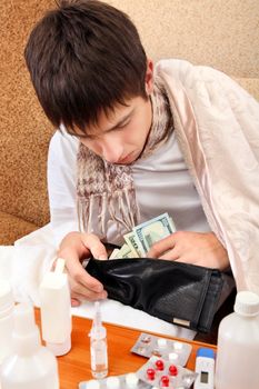 Sick Teenager checking the Wallet on the Sofa at the Home