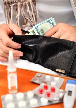 Sick Person checking the Wallet with the Pills on foreground closeup