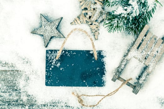 Christmas decoration over snow, wooden background