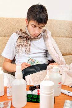 Sick Teenager checking the Wallet on the Sofa at the Home