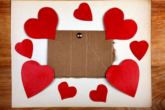 Notice Board with Heart Shapes on Wooden Background
