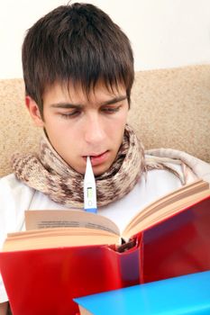 Sick Teenager with Thermometer reads the Books at the Home