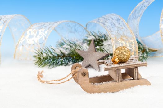 Christmas decoration over snow, blue background