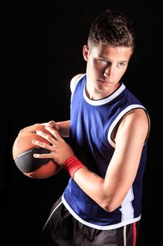 Basketball player with ball on black background 