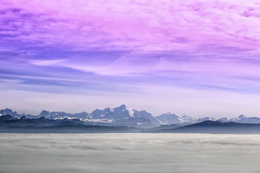 Mont-Blanc in Alps mountains range upon clouds by sunset, France