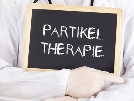 Doctor shows information: particle therapy in german language