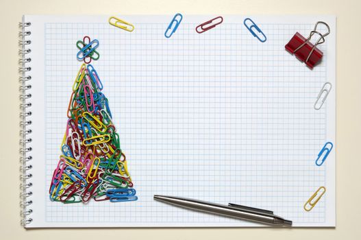 Christmas greeting card made of colorful clips and other office supplies