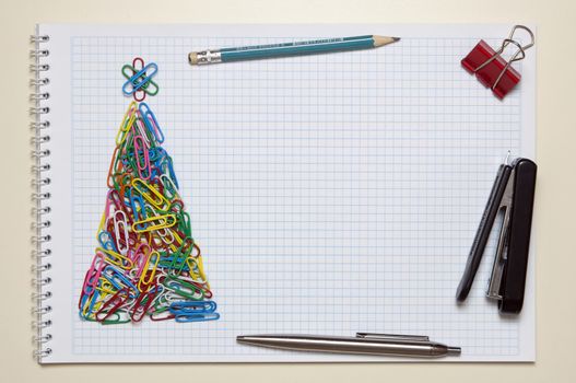 Christmas greeting card made of colorful clips and other office supplies