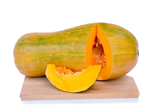 Ripe pumpkin on a cutting Board, cut along, see the middle of the pumpkin and sunflower seeds. Presented on a white background.