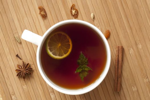 Cup of tea with lime, mint and various spices