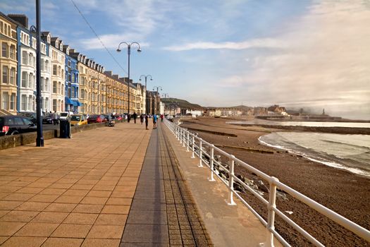 Aberystwyth is a seaside resort with a long promenade, and is situated on the Welsh coast.
